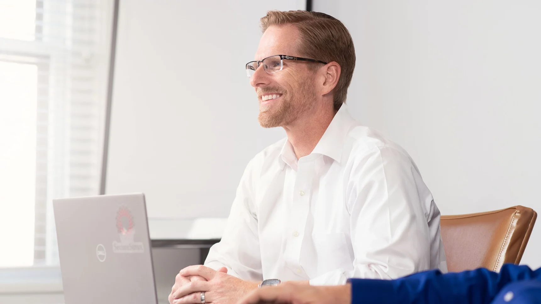 man in white business shirt at laptop
