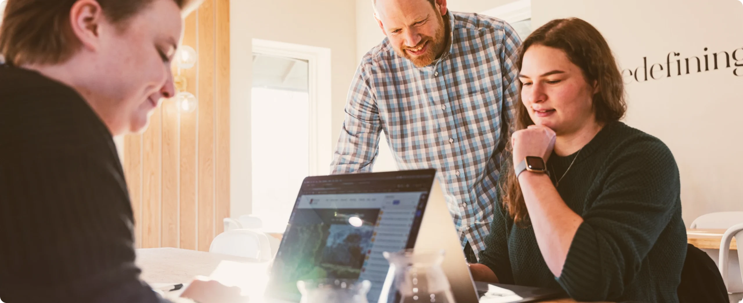 Cross & Crown Web Team in meeting featuring Trevor, Hannah, and Leah.