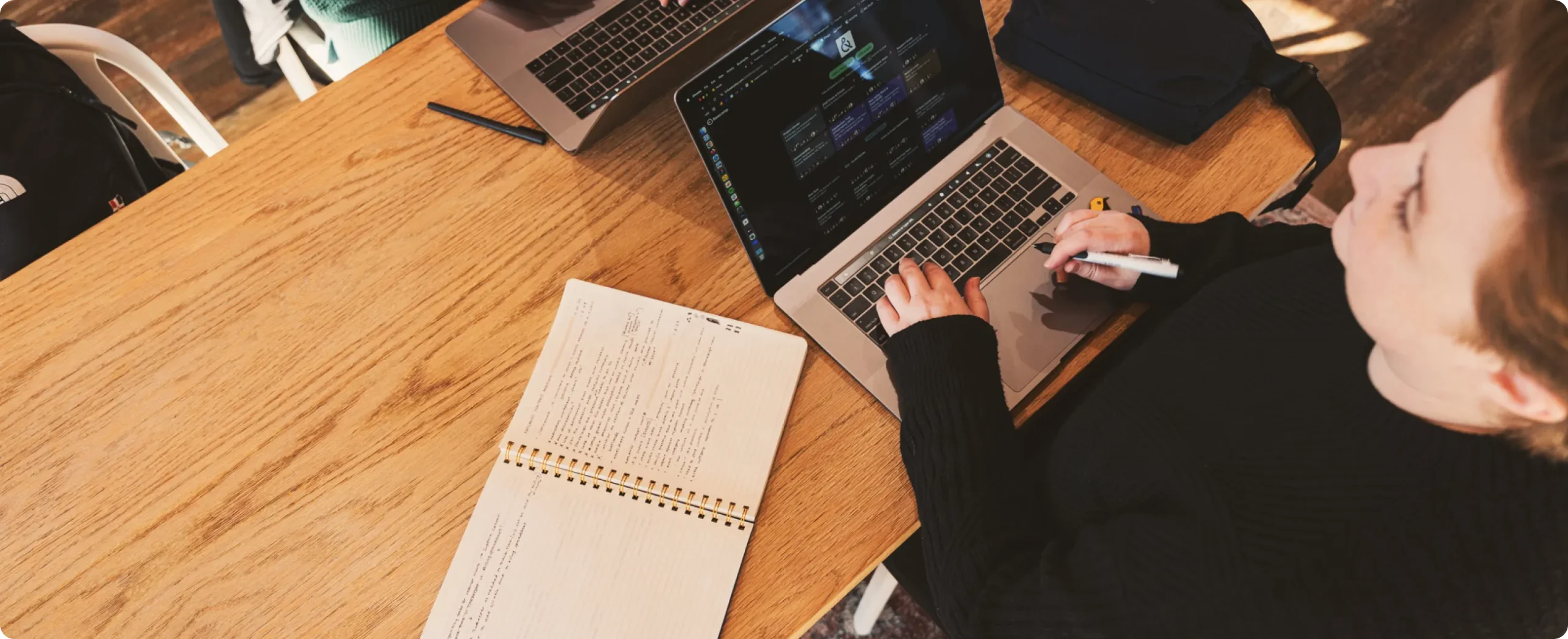 Leah in front of computer with her trusty notebook