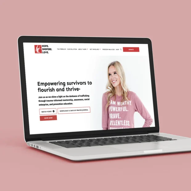 Hope Inspire Love laptop mockup of the homepage against a dusty rose background.