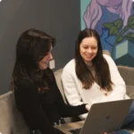 Two women working together on laptop
