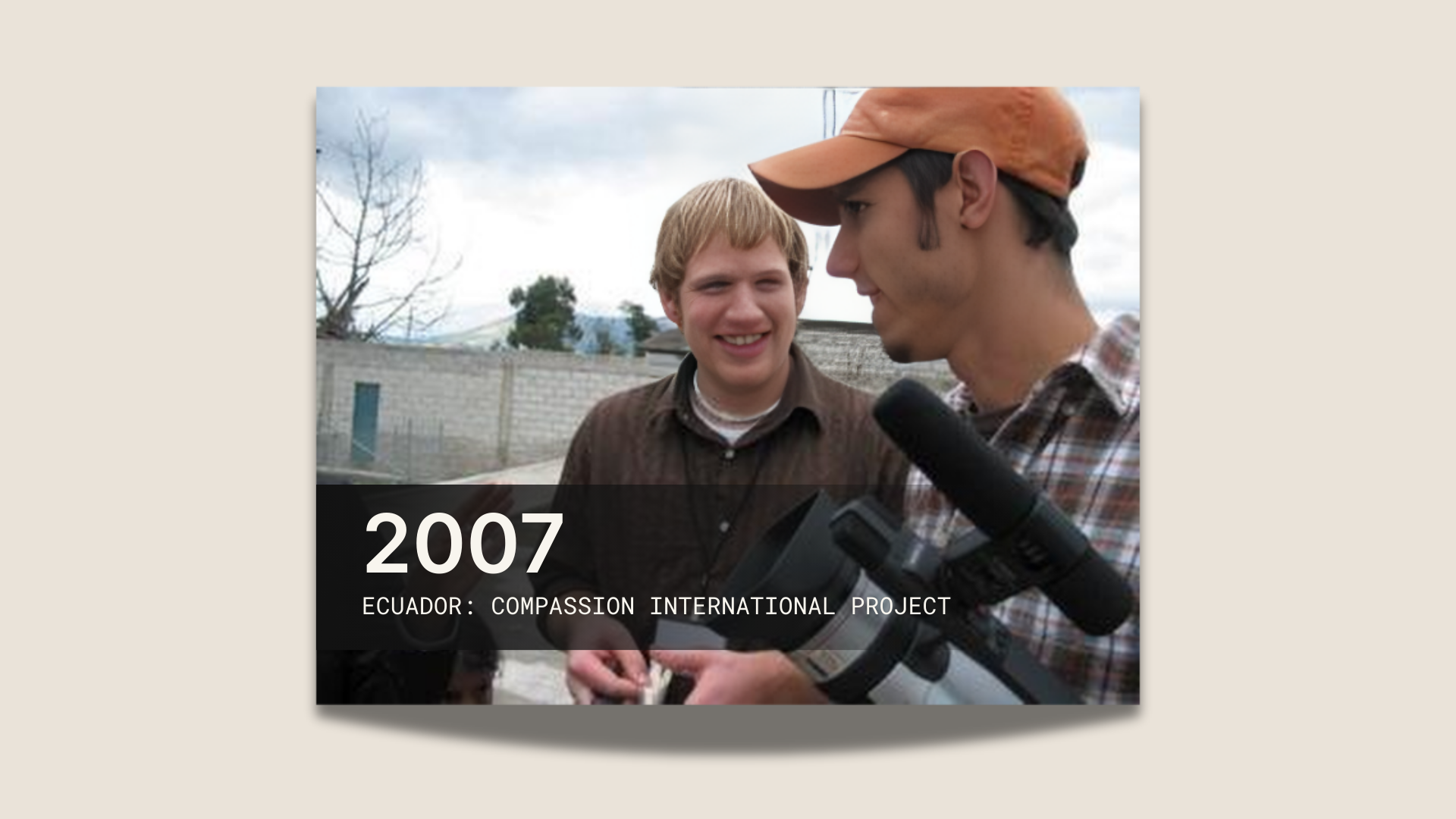 Three people smiling while holding a camera