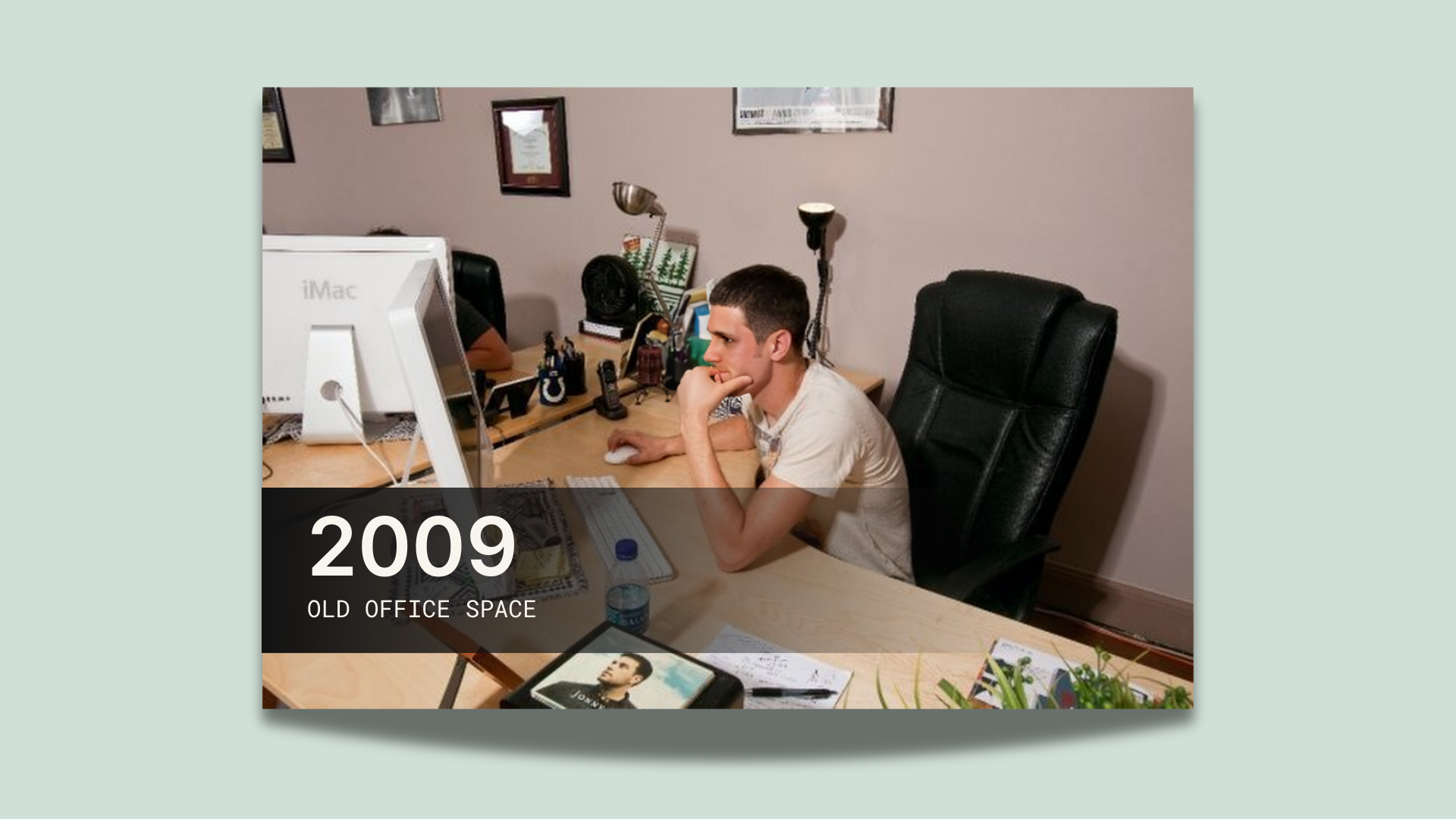 a person sitting at a desk in front of a computer