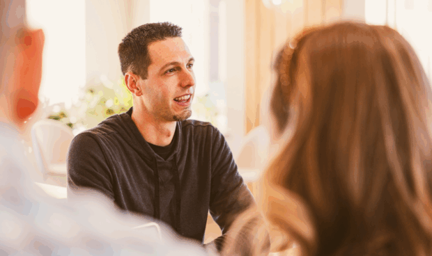 a person talking to a group of people at a meeting