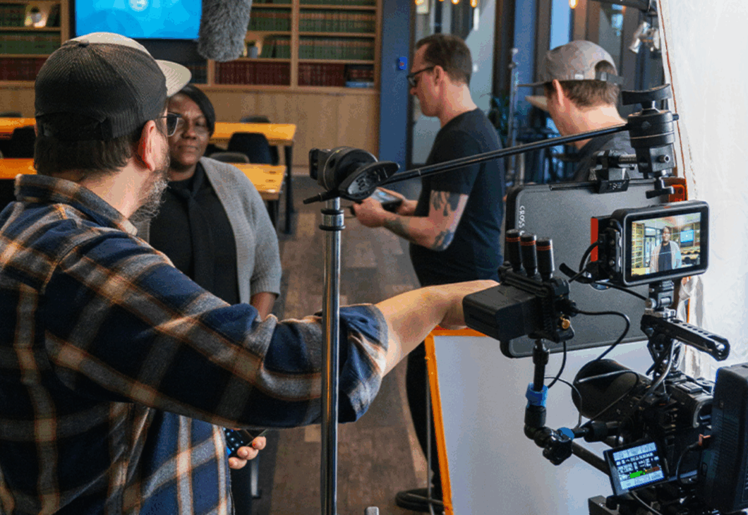 A person standing in front of a video camera in a room