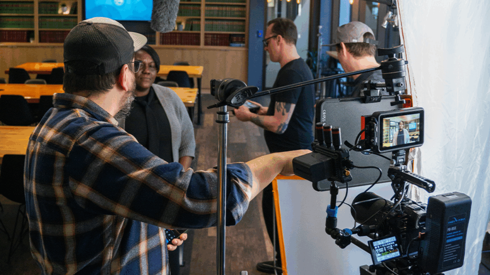 A person standing in front of a video camera in a room