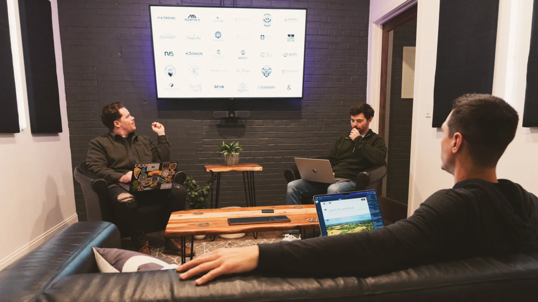 A person looks at a computer screen displaying a website with images of people hiking and text about graphics and trails.